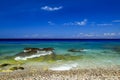 Sea background. Picturesque summer beach, pebbles on a beautiful turquoise sea, Rhodes, Greee Royalty Free Stock Photo