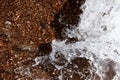 Sea background. Waves on the background of pebbles. Seashore