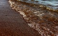 Sea background. Waves on the background of pebbles. Seashore