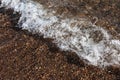 Sea background. Waves on the background of pebbles. Seashore