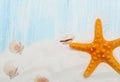 Sea background with white sand and blue painted wood, starfish, shells Royalty Free Stock Photo
