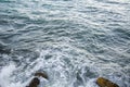 Seascape, seafoam of storm on wild rocky seashore