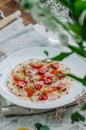Sea bass carpaccio with baked strawberries and citrus dressing. Dish in the restaurant, strawberry menu. Royalty Free Stock Photo