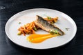 Sea bass with vegetables stir fry, seared sea bass served with stir fried baby vegetables, healthy lunch or dinner Royalty Free Stock Photo