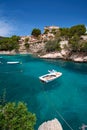 Sea bay a beautiful summer day blue clear water and granite stones. Boats above coral reef. Spain. Royalty Free Stock Photo