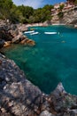 Sea bay a beautiful summer day blue clear water and granite stones. Boats above coral reef. Spain. Royalty Free Stock Photo