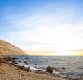 Sea bay with stony beach at the sunset Royalty Free Stock Photo