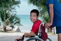 Sea beach with father,Lifestyle of disability child and parent Royalty Free Stock Photo