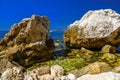 Sea beach with stones and rocks, Beausoleil, Nice, Nizza, Alpes-Maritimes, Provence-Alpes-Cote d `Azur, Cote d `Azur, French Rivie Royalty Free Stock Photo