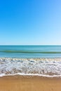 Sea beach with surf and blue sky Royalty Free Stock Photo