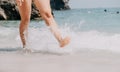 Sea beach travel - woman walking on sand beach leaving footprints in the white sand. Female legs walking along the Royalty Free Stock Photo