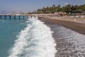 Sea and beach in Turkey. Seaside vacation in Alanya in summer. The coast of the resort area. Waves on the coast.