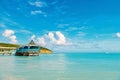 Sea beach with wooden shelter on sunny day in antigua. Pier in turquoise water on blue sky background. Summer vacation Royalty Free Stock Photo
