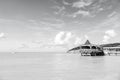 Sea beach with wooden shelter on sunny day in antigua. Pier in turquoise water on blue sky background. Summer vacation Royalty Free Stock Photo