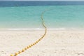 Sea beach with yellow buoys.