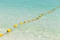 Sea beach with yellow buoys.