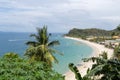 Sea, blue sky, palms and boats in White beach, Puerto Galera, Philippines. Popular tourist and diving spot. Royalty Free Stock Photo