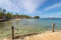 Sea, blue sky, palms and boats in White beach, Sabang, Puerto Galera, Philippines. Popular tourist and diving spot. Royalty Free Stock Photo