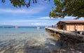 Sea, blue sky, palms, bungalow and boats in White beach, Sabang, Puerto Galera, Philippines. Popular tourist and diving spot. Royalty Free Stock Photo