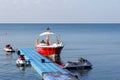 A sea boat and jet skis are moored at the sea pier Royalty Free Stock Photo