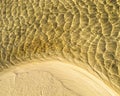 Sea bottom texture, yellow sand waves in shallow water. Royalty Free Stock Photo