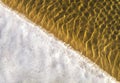 Sea bottom texture, yellow sand waves in shallow water. Royalty Free Stock Photo