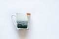 Sea in a broken cup on a white background close up, dreams of the sea, creativity Royalty Free Stock Photo