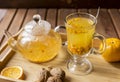 Sea buck thorn tea with orange and nuts at wooden background