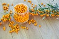 Sea buckthorn berries in a glass jar on a wooden table Royalty Free Stock Photo