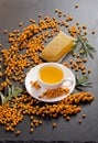 Sea buckthorn, honeycomb with honey and cup of tea Royalty Free Stock Photo