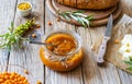 Sea buckthorn jam in a glass jar with butter, fresh berries, leaves and loaf bread Royalty Free Stock Photo