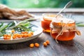 Sea buckthorn jam in glass jars, branch and berries Royalty Free Stock Photo