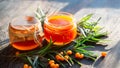 Sea buckthorn jam in glass jars, branch and berries Royalty Free Stock Photo