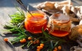 Sea buckthorn jam in glass jars, branch and berries Royalty Free Stock Photo