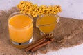 Sea buckthorn juice with honey and cinnamon. Vitamin autumn drink. Royalty Free Stock Photo