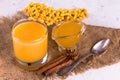 Sea buckthorn juice with honey and cinnamon. Vitamin autumn drink. Royalty Free Stock Photo