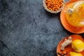 Sea buckthorn tea, top view. Still life kettle, berries and lemons. Orange sea buckthorn drink, juice. Autumn mood. Space for text Royalty Free Stock Photo