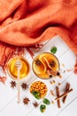 Sea buckthorn tea in wooden bowl, honey, Sea buckthorn juice on white wooden table. top view with copy space for text Royalty Free Stock Photo