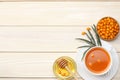 Sea buckthorn in wooden bowl, honey, Sea buckthorn juice on wooden table. top view with copy space Royalty Free Stock Photo