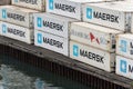 Sea cargo containers stacked on pier in container terminal commercial seaport