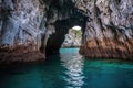 sea cave entrance surrounded by turquoise waters Royalty Free Stock Photo