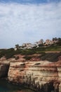 Sea Caves, Rocky Coast with a city above