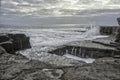 Sea cliffs hole in the rock named The Wormhole on Aran Islands,