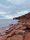 Sea cliffs under an overcast sky at Cavendish Beach, Prince Edward Island, Canada. Vertical shot Royalty Free Stock Photo