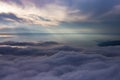 sea of clouds below and the sea ahead, the rays of the sun Royalty Free Stock Photo