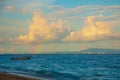 Sea, clouds, boat, rainbow. Nusa Dua Bali. Geger Beach. Indonesia. Royalty Free Stock Photo