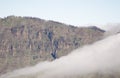 Sea of clouds descending the slope of The Chapin Cliffs.