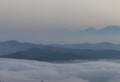 A sea of clouds and fog fills the valleys of the Apennine mountains at sunset Royalty Free Stock Photo