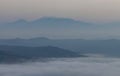 A sea of clouds and fog fills the valleys of the Apennine mountains at sunset Royalty Free Stock Photo