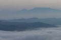 A sea of clouds and fog fills the valleys of the Apennine mountains at sunset Royalty Free Stock Photo